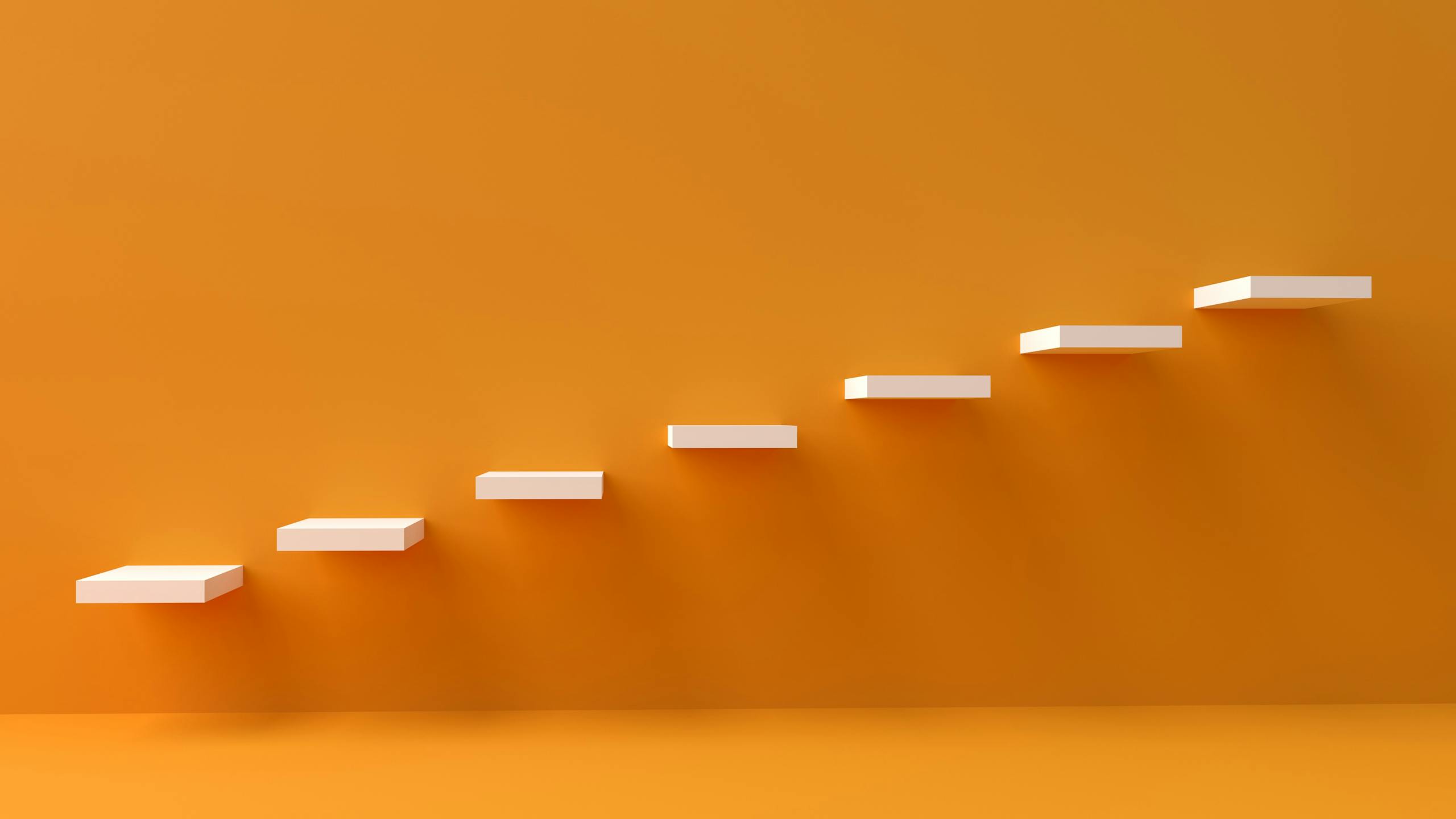 White floating steps on vibrant orange wall create a minimalist and conceptual design.